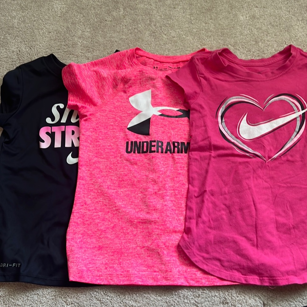 Three Nike and UA shirts